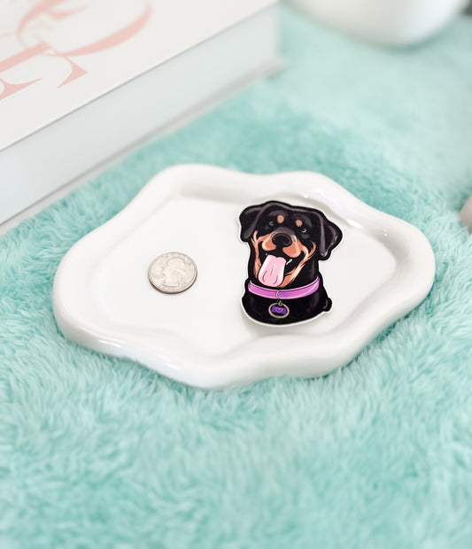 Pin with a dog design sticker on a white surface