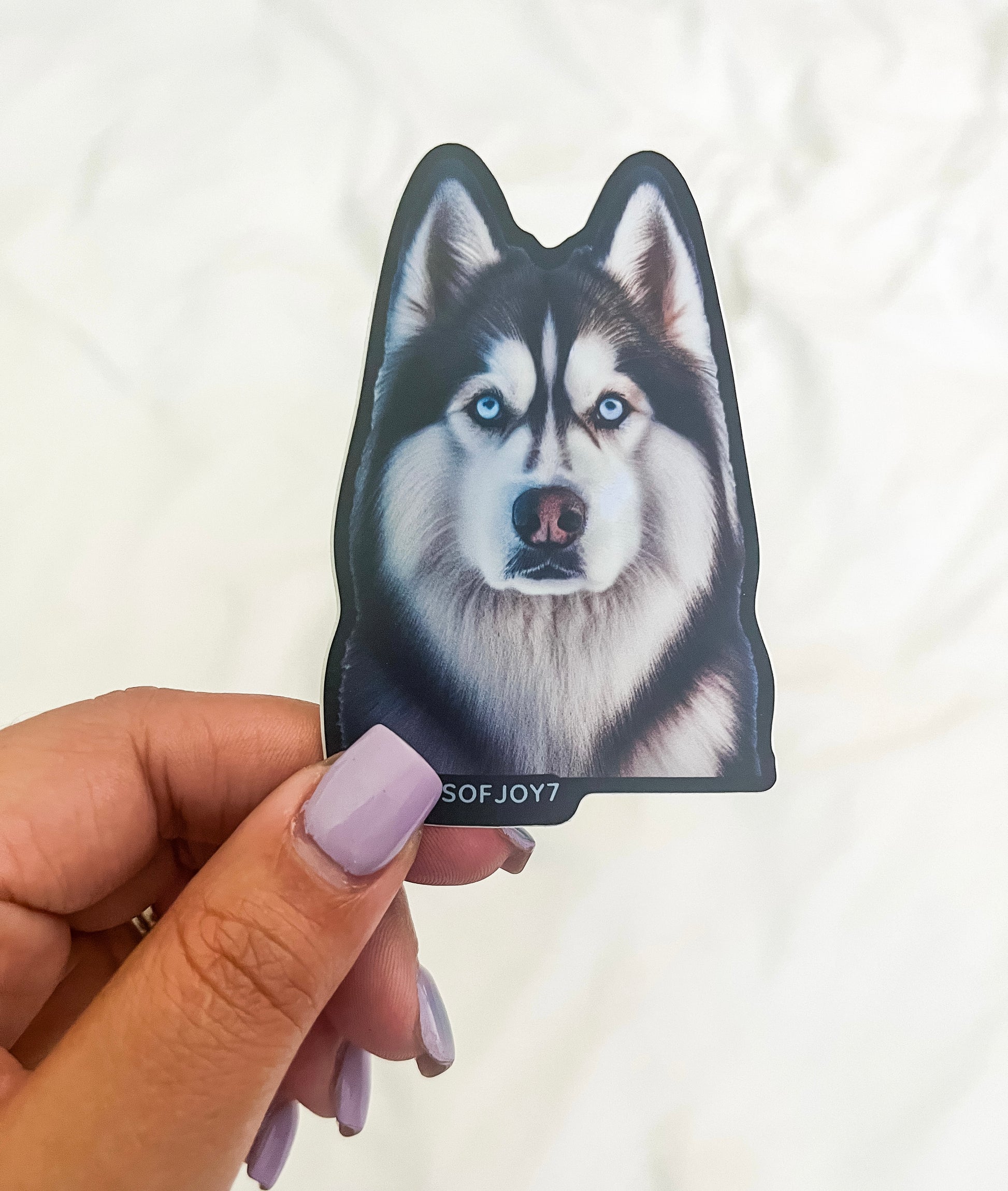 Boutique-designed Husky vinyl sticker featuring a bold dog silhouette with bright eyes and thick coat, waterproof and durable, created to honor the wild yet loyal bond between Husky dog moms and their pups.