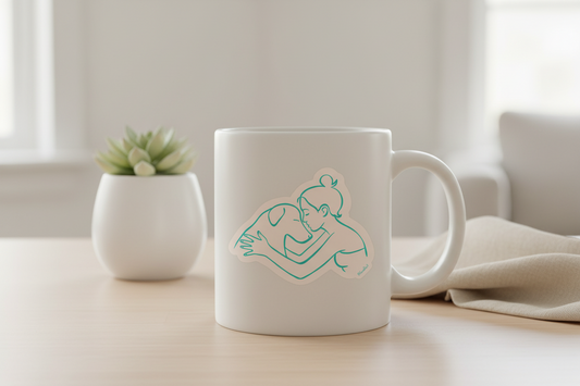 White mug with a design on a light surface with a plant and blanket in the background
