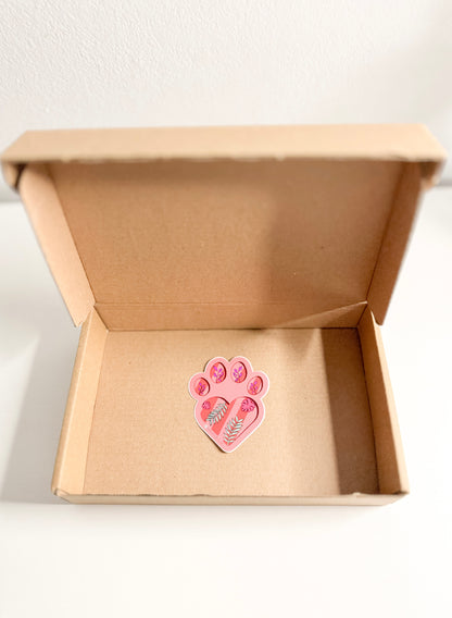 Pink paw print design in a cardboard box on a white background