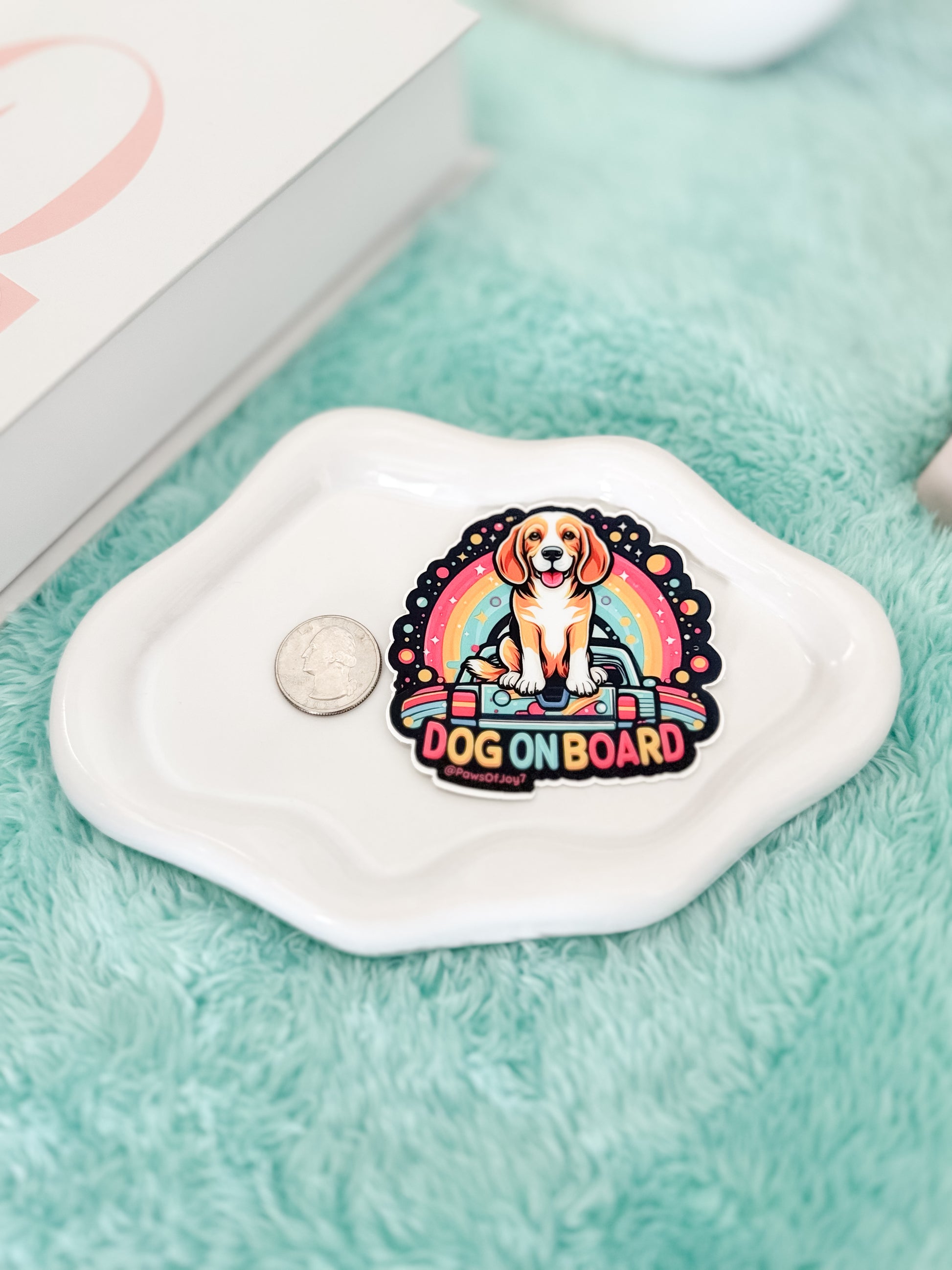 Sticker with a dog design and 'Dog on Board' text on a white surface.